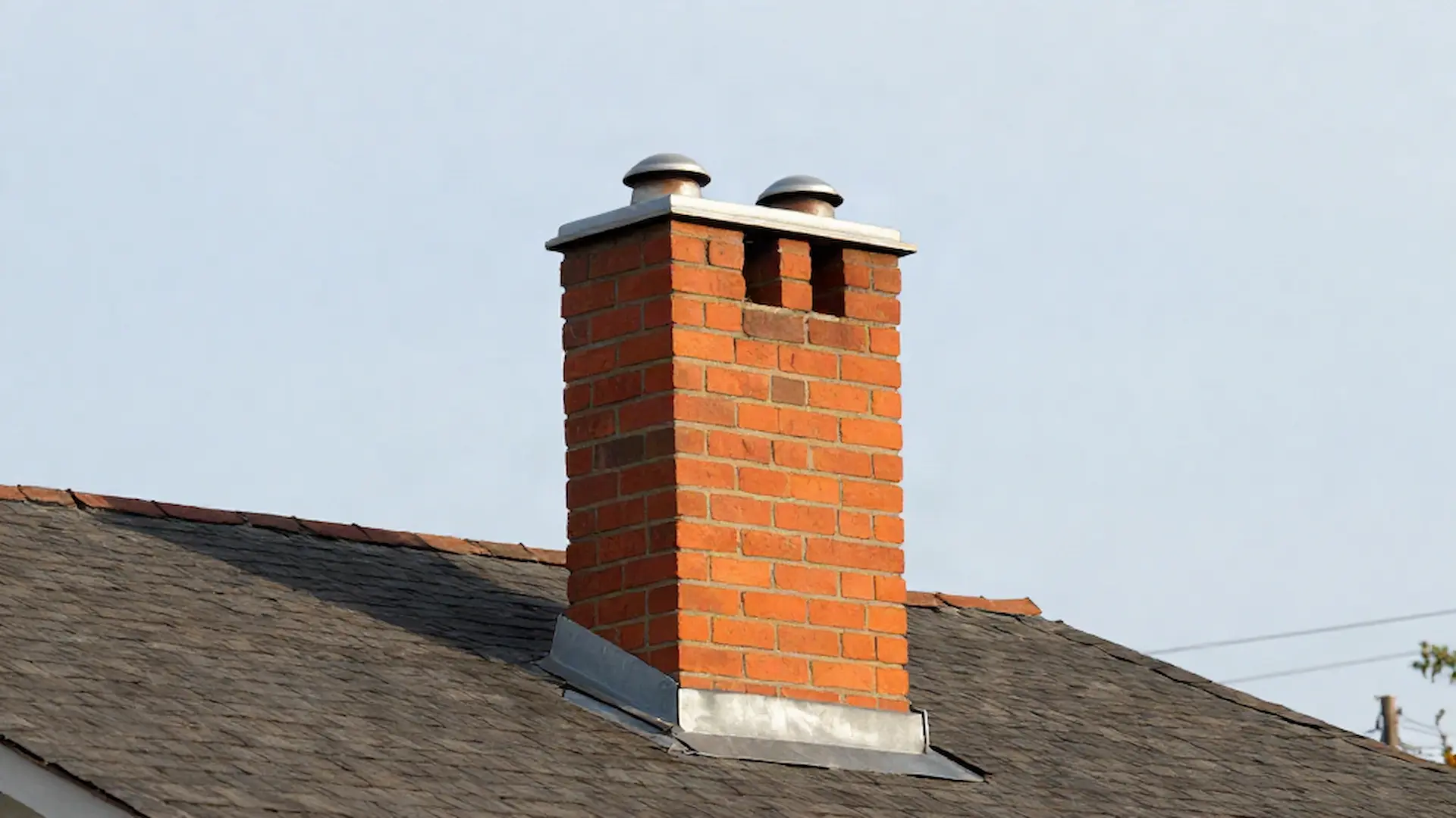 Brick chimney on a home served by Cast Iron Chimney Sweeps in Philadelphia, PA